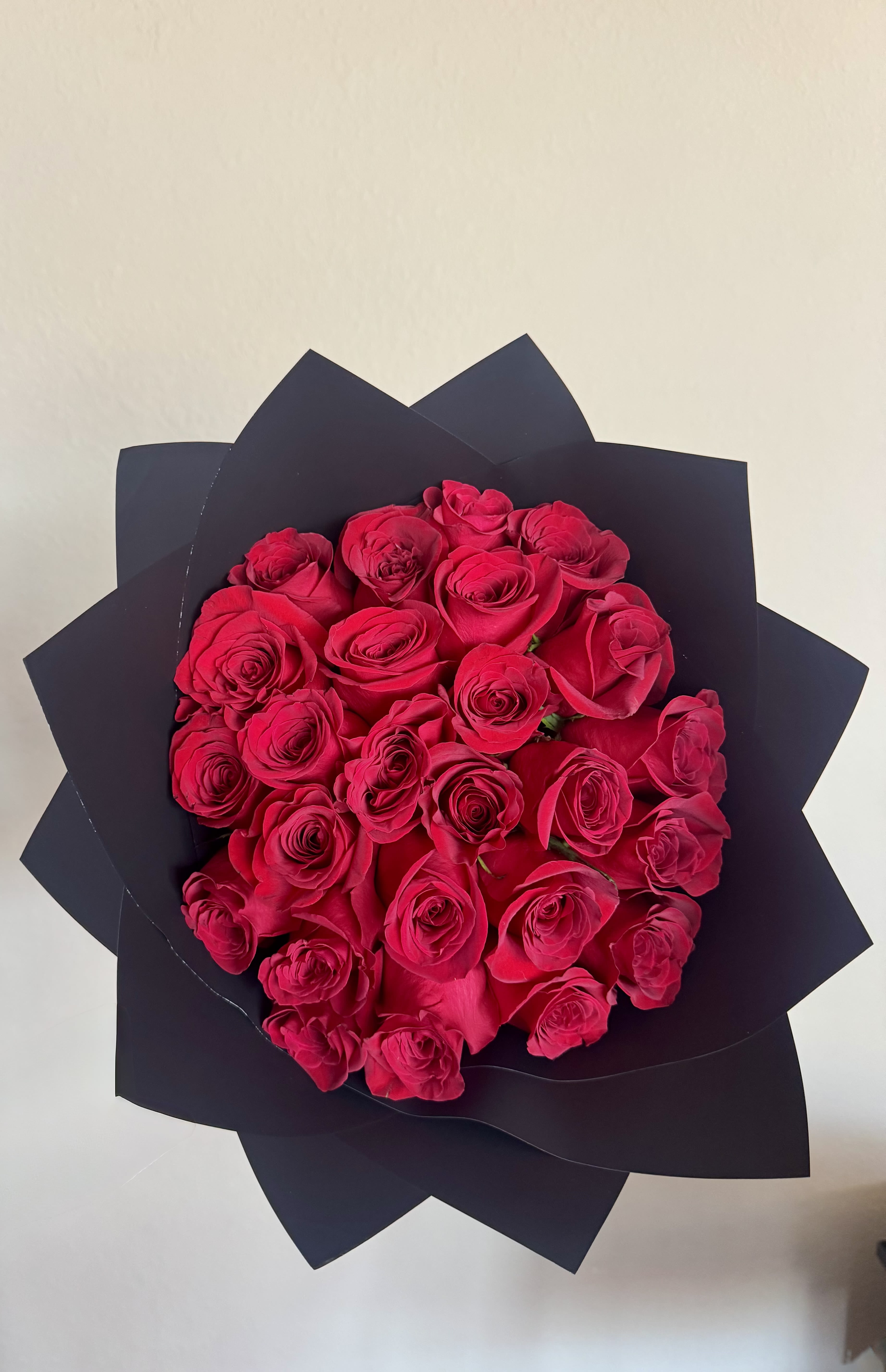 Red Love Bouquet  - Our Ramo Buchón is a luxurious hand-wrapped bouquet designed to make a lasting impression. Featuring premium fresh Ecuadorian  roses wrapped in elegant floral paper.  **Wrapping paper is subject to availability. While the design or pattern may vary, we will do our best to use a similar color and maintain the overall look of the bouquet.**