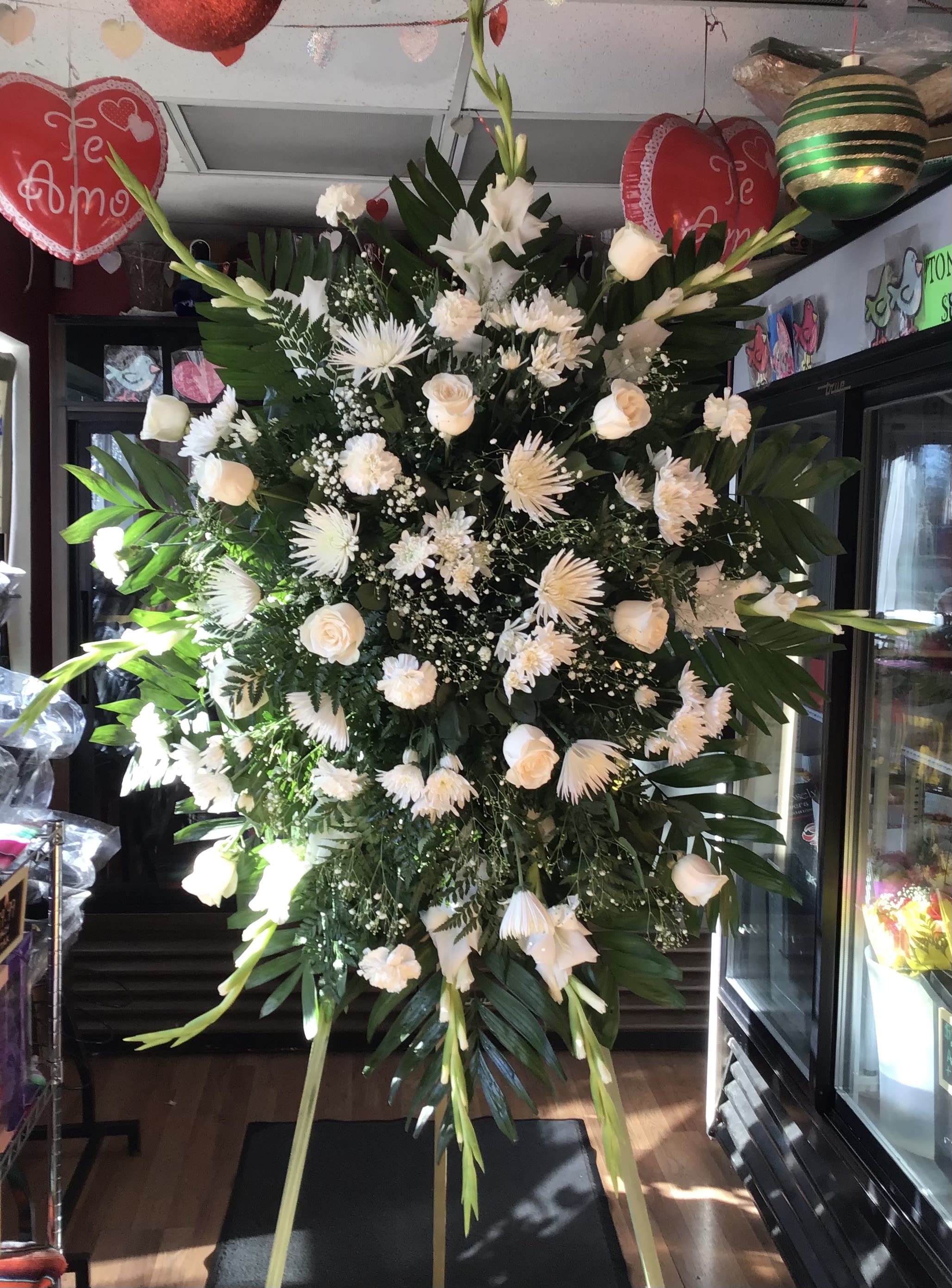 Sympathy Deluxe Standing Spray  - A classic sympathy Spray featuring fresh Chrysanthemum, and roses creating a graceful and heartfelt tribute. 