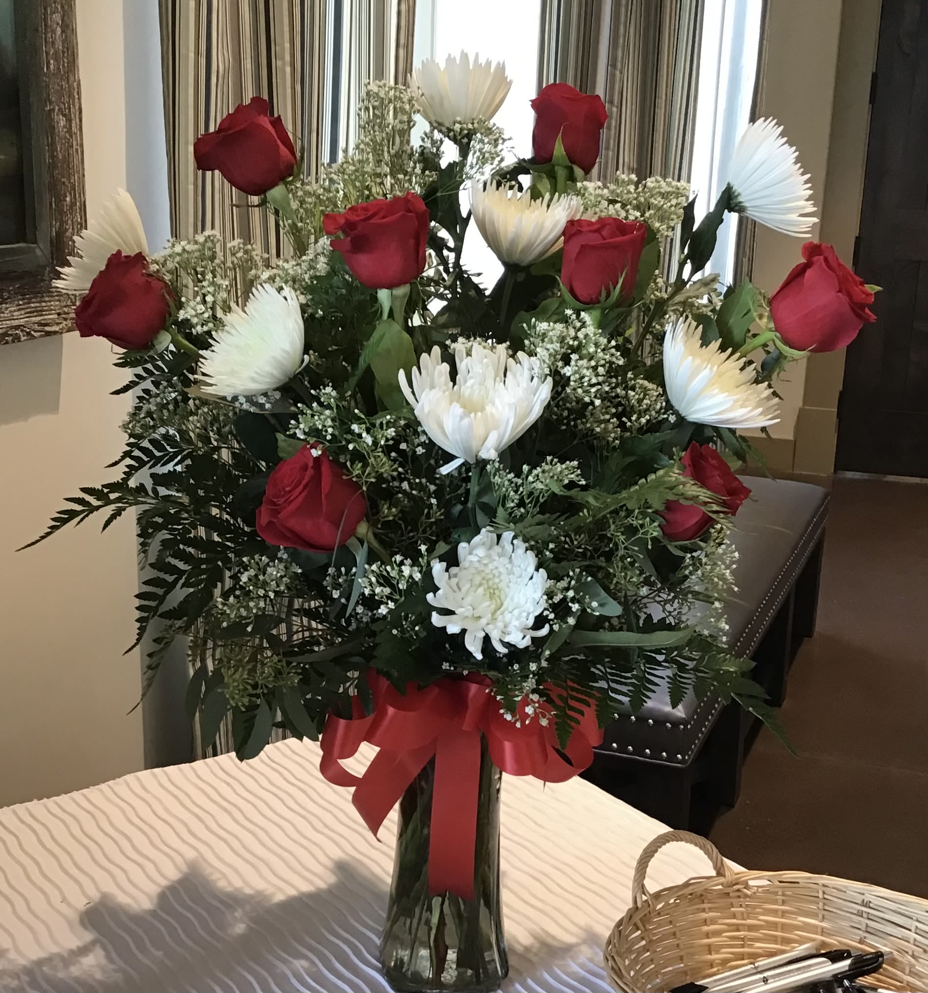 Memorial Table Arrangement - Beautiful vase arrangement with roses and spider mums. This is a perfect arrangement for the memorial table where visitors sign and leave a message.   If you would like one of the available colors below, please specify your preference in the Special Instructions section when placing your order, if not then the order will be made with red roses. Color requests are subject to availability.  Available Colors:  1)Pink 2)Yellow 3)Off-White 4)Fuchsia