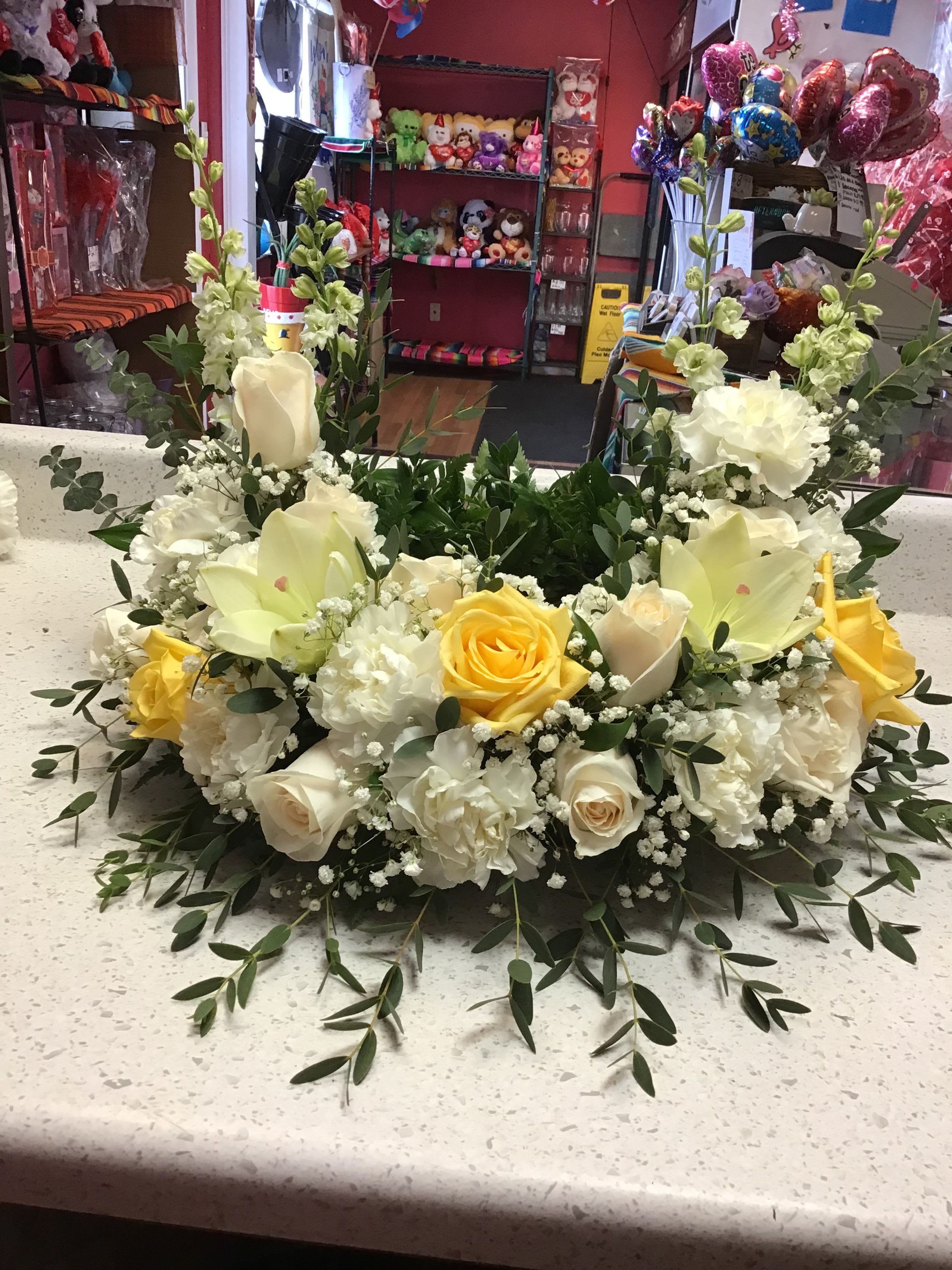 Comfort &amp; Peace Urn Arrangement -  Honor the memory of a loved one with our Comfort &amp; Peace Urn Arrangement. Crafted with a full ring of pristine white carnations and accented with rich roses, baby's breath, and fresh greenery.