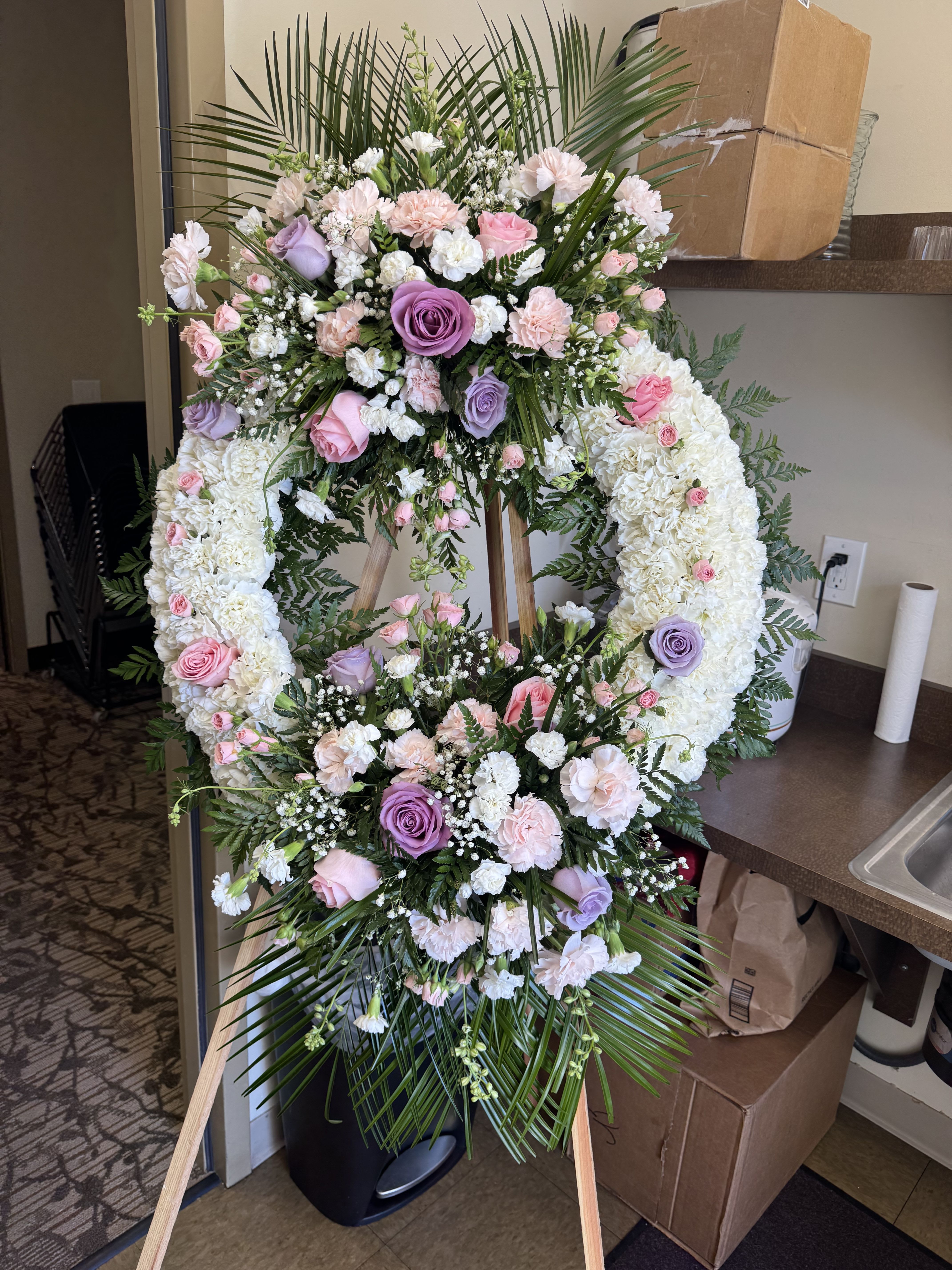 Garden of Grace - A symbol of eternal love and peaceful remembrance, the Garden of Grace Wreath is thoughtfully created to honor a cherished life. Its graceful beauty serves as a touching expression of sympathy and a lasting tribute to unforgettable memories.