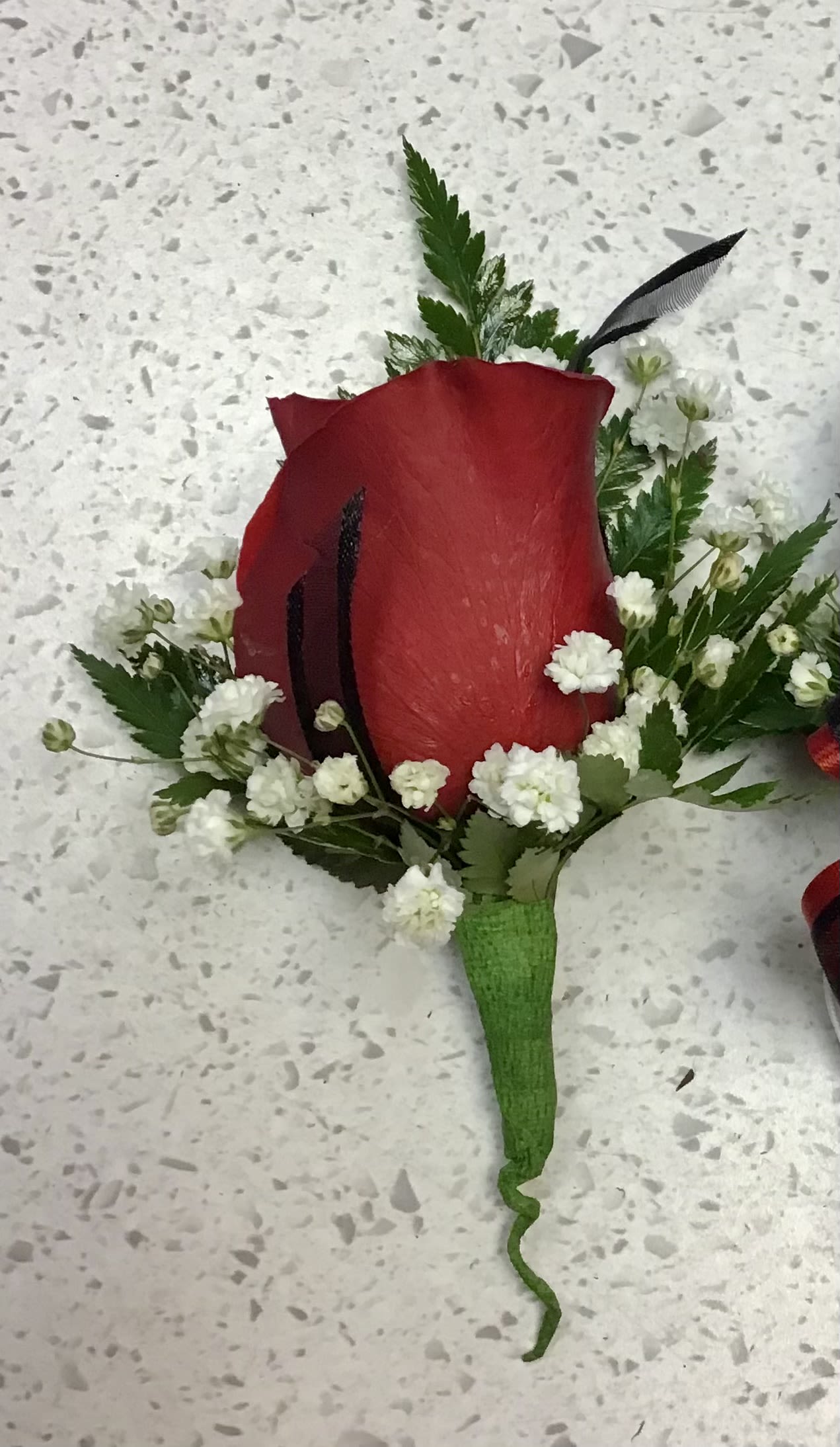 Boutonniere  - simple yet elegant boutonniere that is perfect for your wedding, prom, or any other event.   Available Rose Colors:  1) Yellow 2) Off-White 3) Pink 4) Lavender  **Please specify your preferred rose color in the Special Instructions section. Color requests are subject to availability. If no color is requested, red roses will be used.**  **Please note that ribbon style and design may vary. If you would like a specific ribbon color, please include your request in the Special Instructions section. While we cannot guarantee an exact match, we will make every effort to use a ribbon that closely matches your preferred color.*
