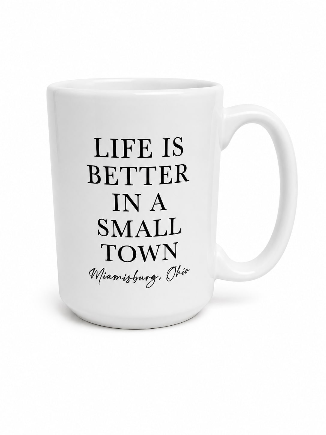 White mug with black text reading "Life is better in a small town"