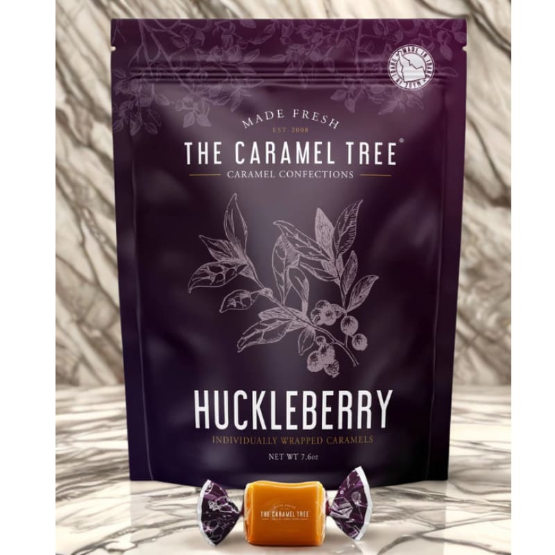 The Caramel Tree Huckleberry Individually Wrapped Caramels - Huckleberry Caramels. Named Idaho’s state fruit in 2000, the huckleberry is a wild berry prized for its deep color and bold, sweet-tart flavor. These berries grow only in the remote mountain regions of the Northwest, making them as rare as they are delicious.  Our signature smooth, buttery caramel pairs perfectly with this vibrant mountain berry, creating a one-of-a-kind indulgence. The perfect souvenir, a gift to show your Rocky Mountain pride, or simply a treat to savor.