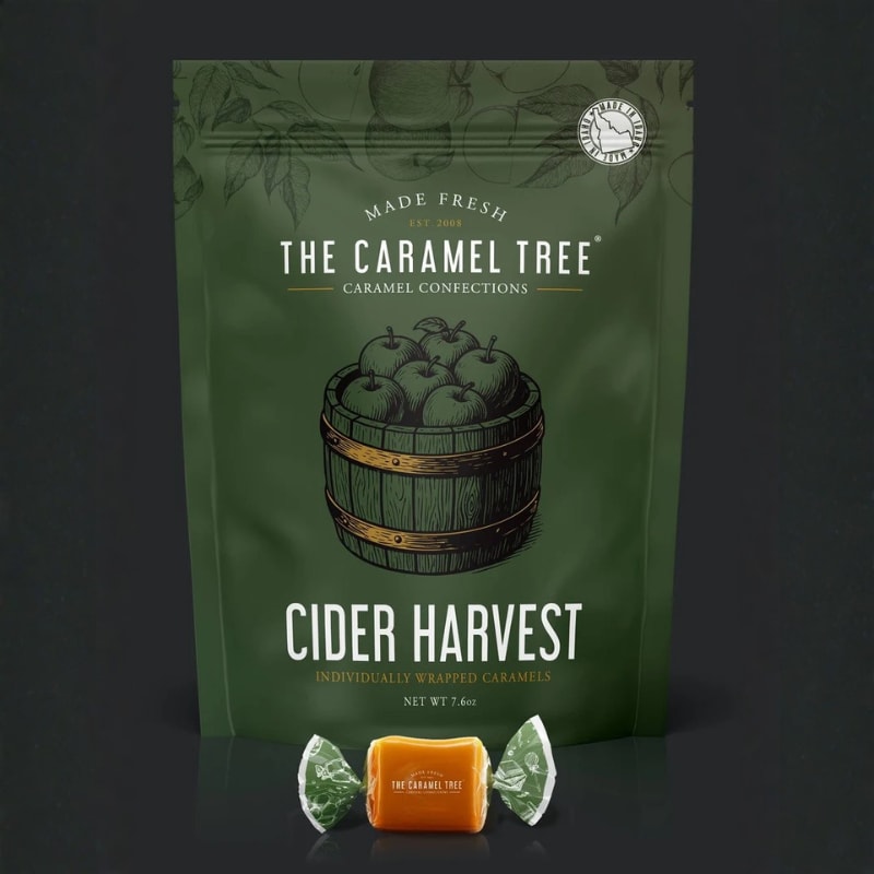 Green bag of caramel candies with one wrapped caramel in front