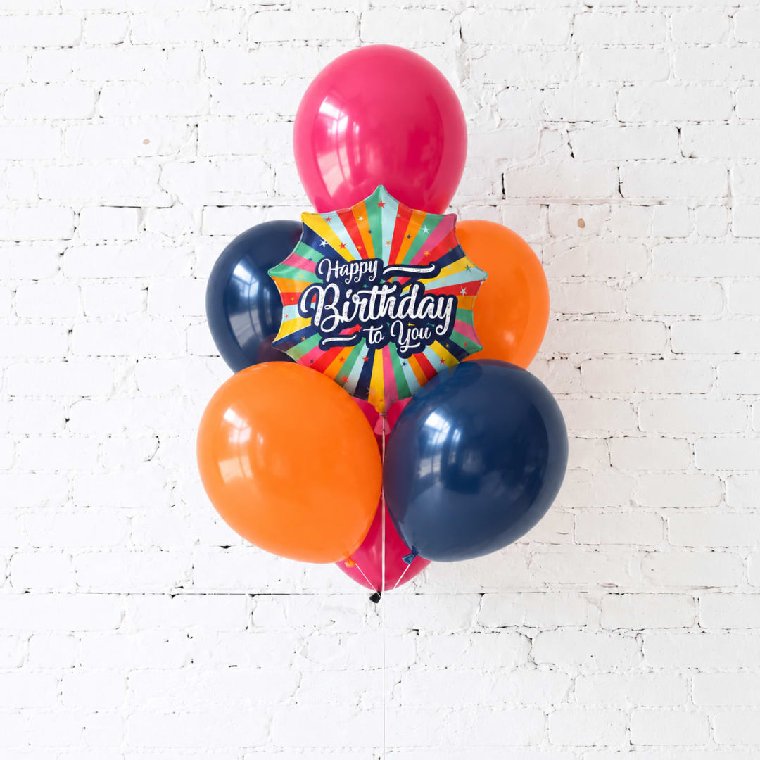 Birthday balloon bouquet with a colorful starburst foil balloon and round balloons