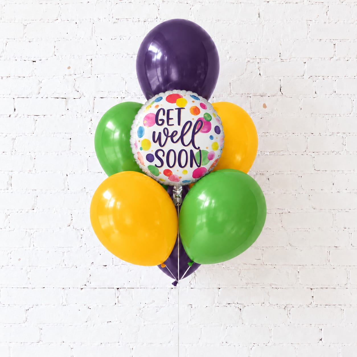 Cluster of colorful balloons with a "Get Well Soon" balloon