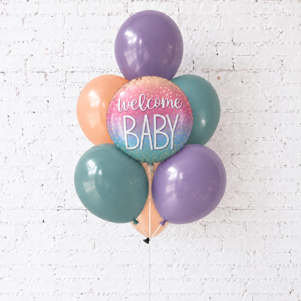 Pastel balloon cluster with a "welcome baby" foil balloon