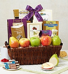 Gift basket of apples, pears, and assorted gourmet snacks topped with a purple bow