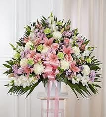 Pink, white and green pastel funeral basket - These soft pastel colors are arranged in a traditional design to send thoughts of comfort.