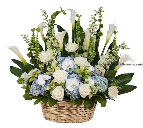 Tall white and blue flower arrangement with calla lilies and roses in a woven basket