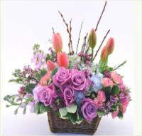 Basket arrangement of pink and purple roses with tulips