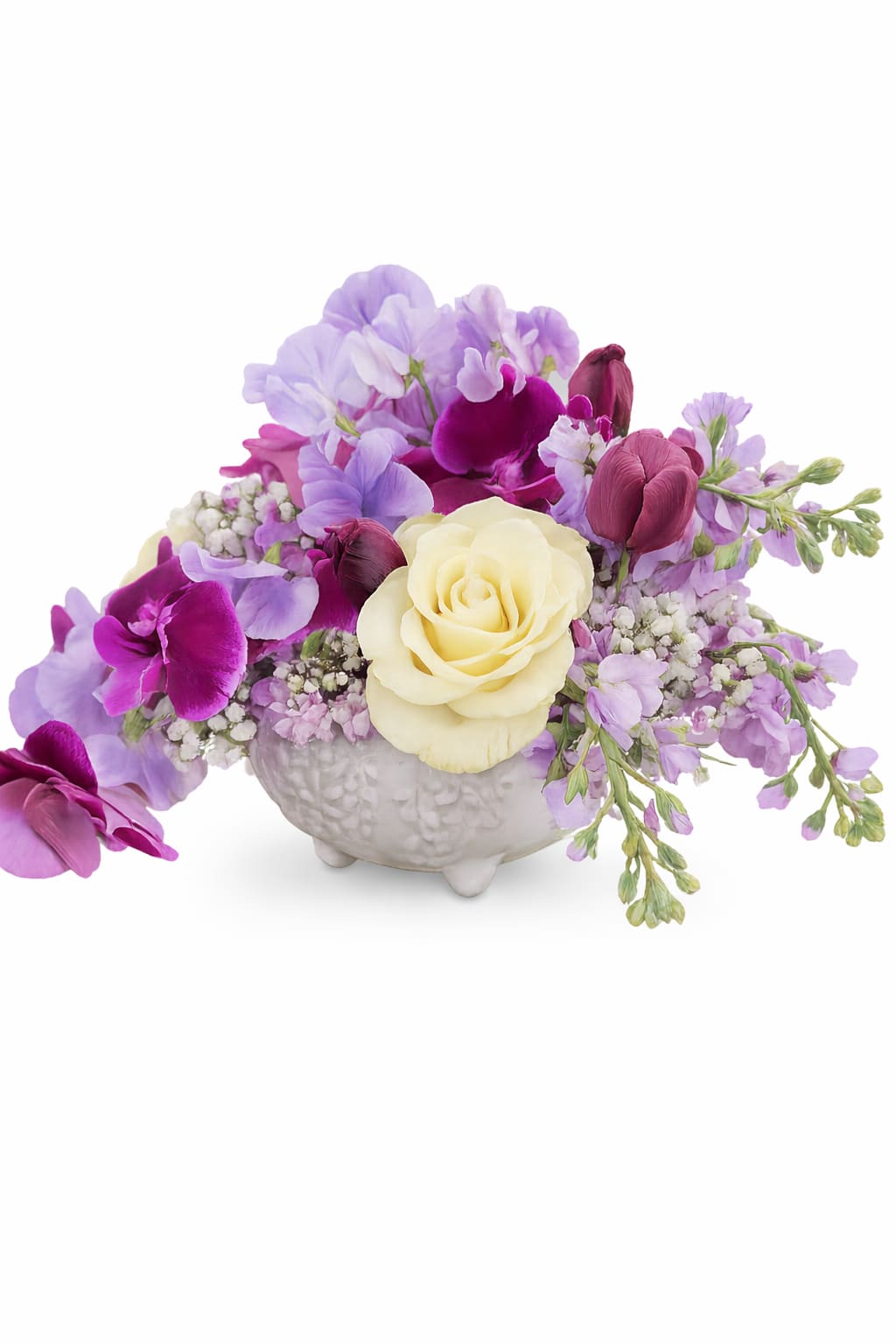 Purple and cream floral arrangement in a white ceramic vase