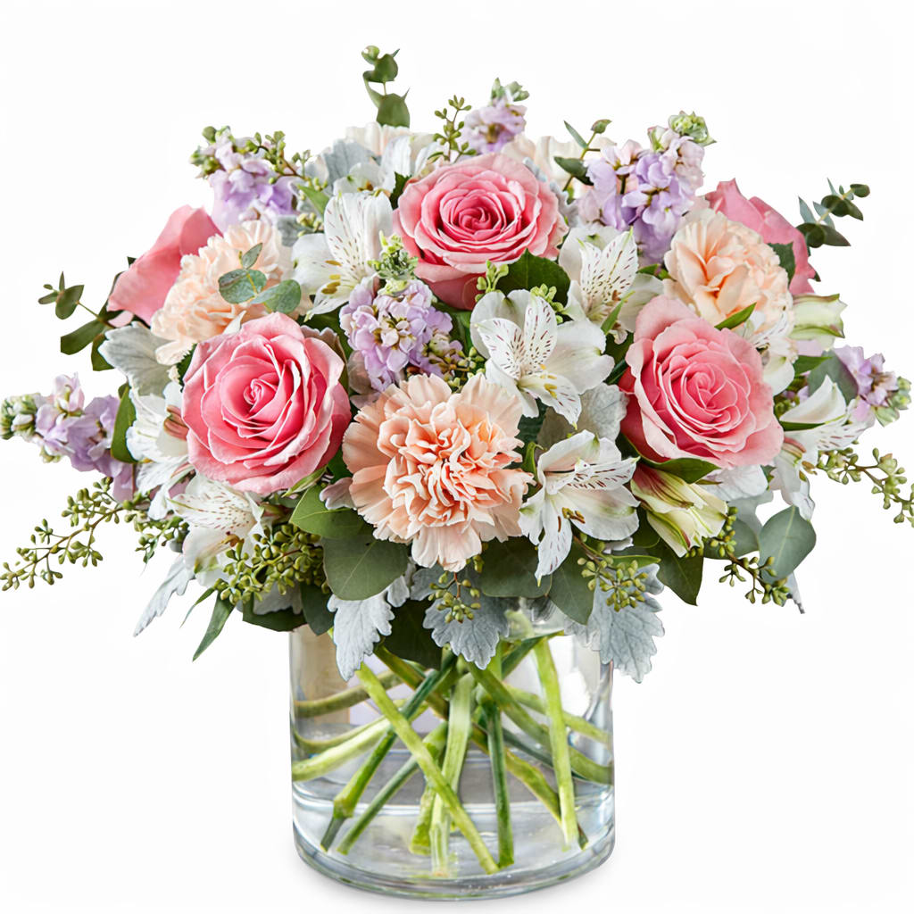 Pink roses and peach carnations in a clear glass vase