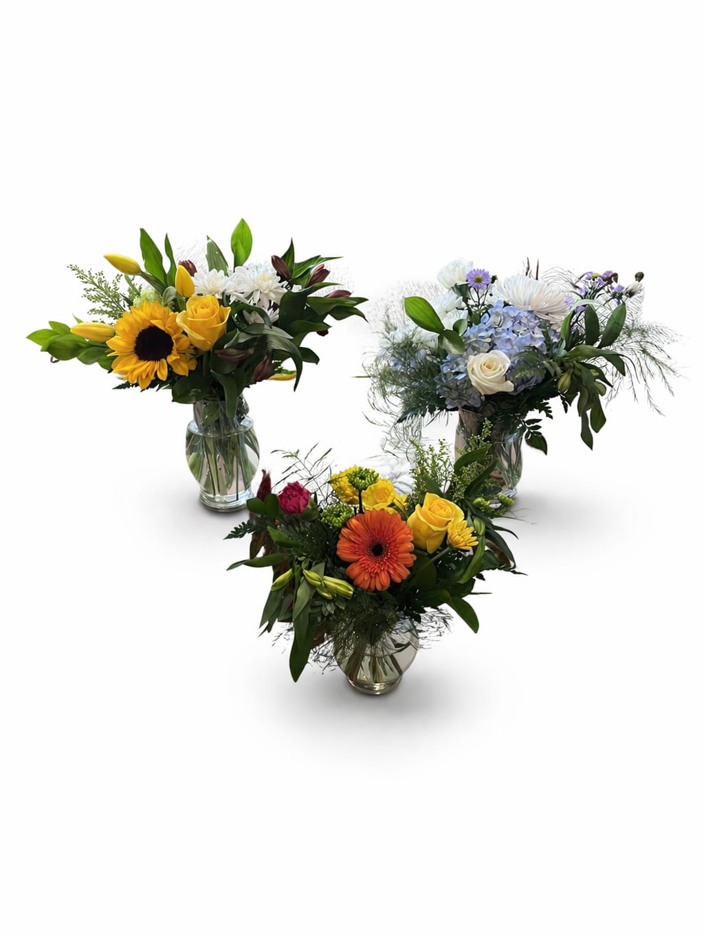 Administrator Trio Package - Show your appreciation with our thoughtfully designed Administrator Trio Package—a stunning collection of three hand-crafted floral arrangements, each with its own unique style and color palette.   A bright and cheerful sunflower &amp; yellow rose arrangement for warmth and positivity  A soft and elegant blue hydrangea &amp; white rose design for calm and appreciation  A vibrant mixed arrangement with bold seasonal blooms for energy and joy Each arrangement is created in a classic glass vase, making it perfect for desks, reception areas, or shared office spaces.