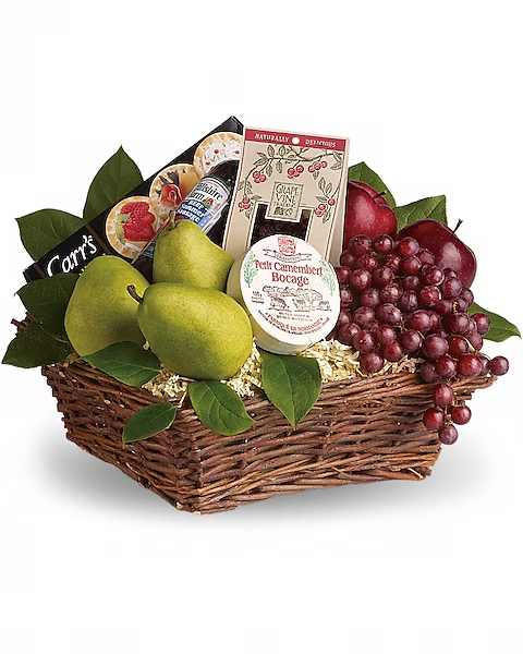 Gift basket with pears, grapes, cheese, and crackers in a wicker tray