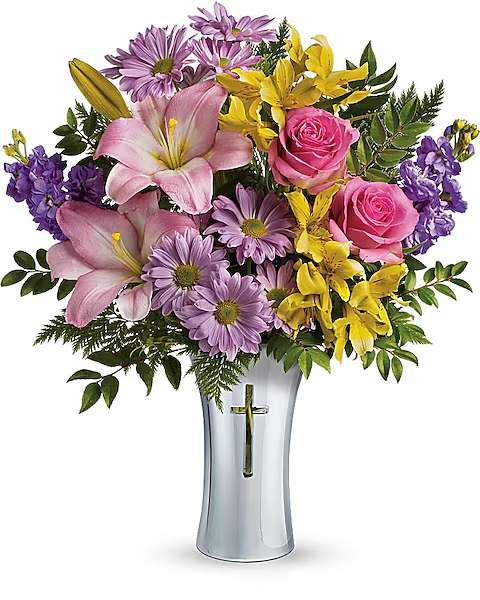 Pink lilies, roses, and purple daisies in a silver vase