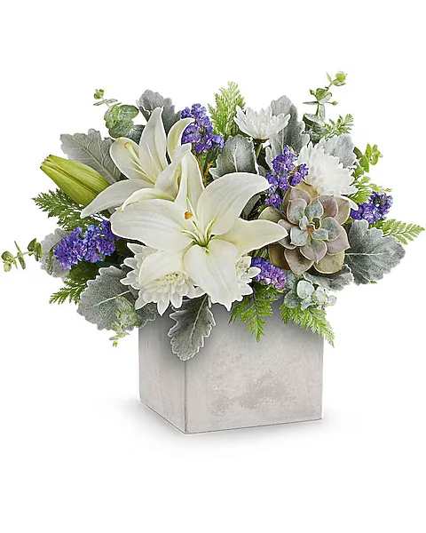 White lilies and purple flowers in a silver square vase