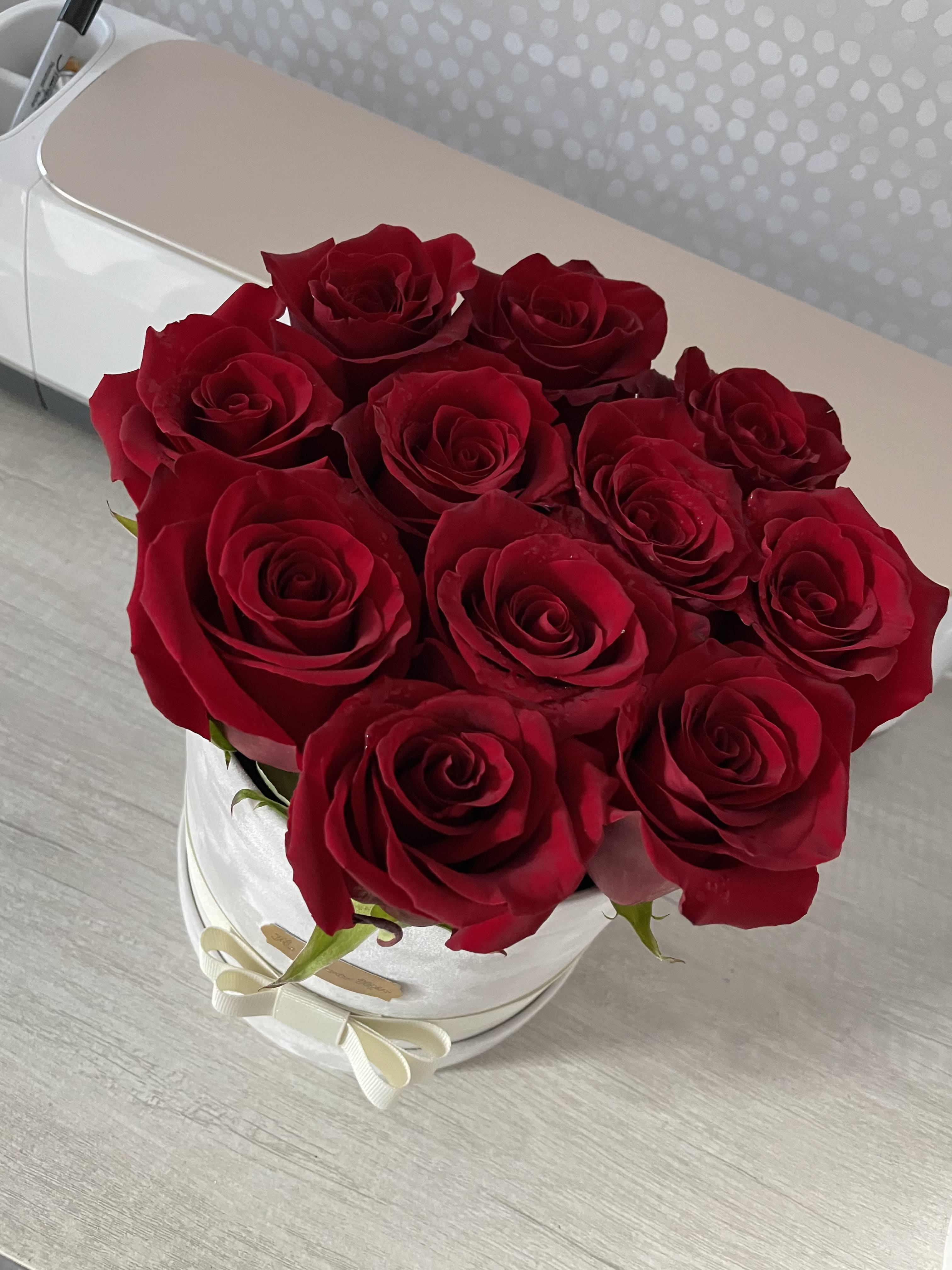 Round Box - Deep red roses packed in a white round hatbox with a delicate ribbon bow-classic, romantic elegance perfect for anniversaries or intimate celebrations.