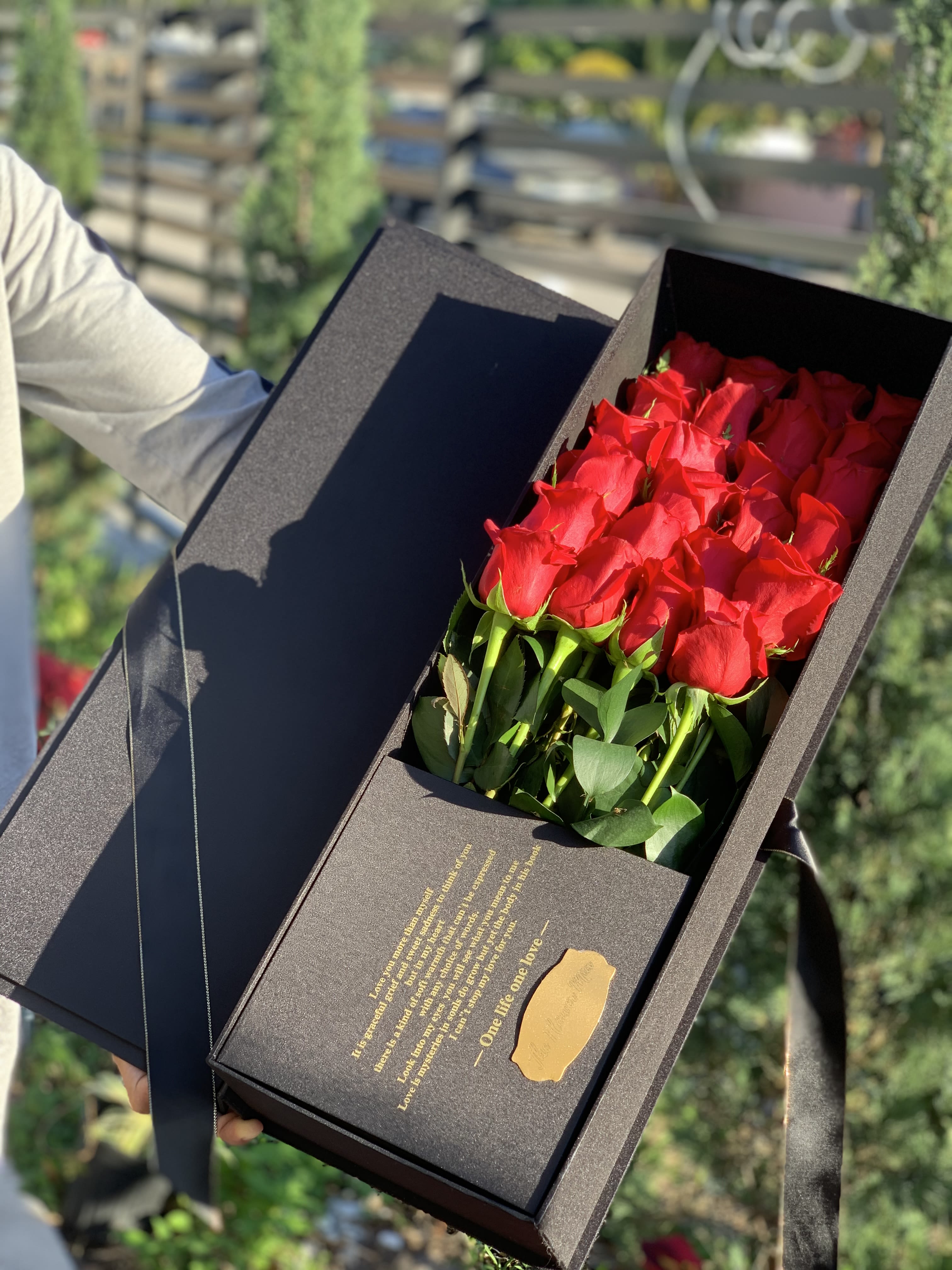 The Prestige Box - Red roses arranged in a sleek black gift box with ribbon and gold accents-dramatic, romantic and perfect for intimate celebrations.
