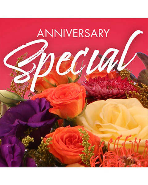 Mixed bouquet of roses and purple blooms with an anniversary card
