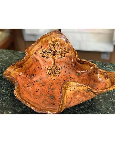 Orange ceramic decorative bowl with a cross design