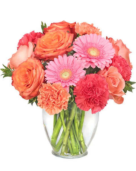 Bouquet of pink and orange flowers in a clear glass vase
