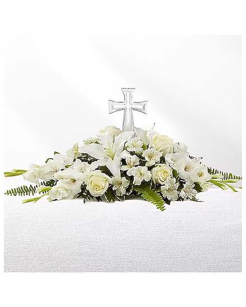 White floral casket spray with a clear cross centerpiece
