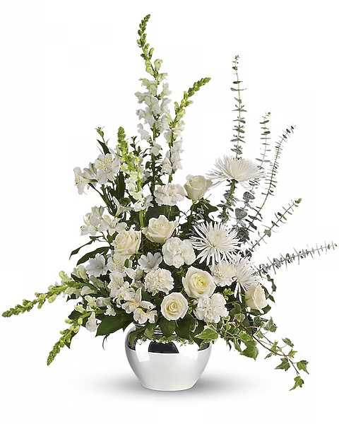 White floral arrangement in a silver vase with tall spiky blooms