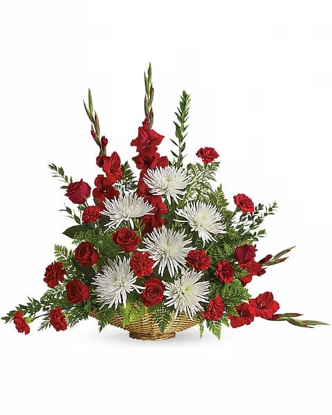 Red and white floral arrangement in a wicker basket