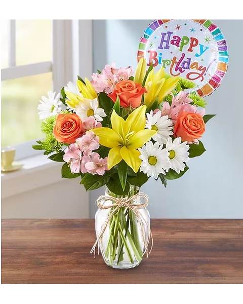 Mixed bouquet in a glass vase with a birthday balloon