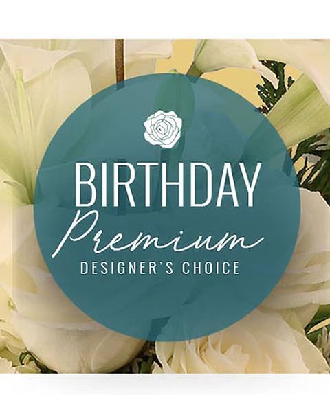 White calla lilies behind a birthday premium designer's choice label
