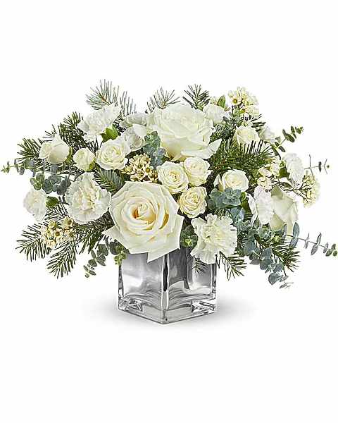 White roses and carnations in a clear square vase