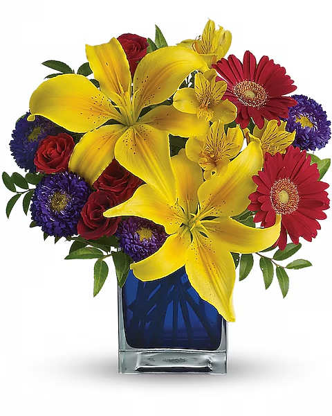 Bright mixed bouquet with yellow lilies, red gerberas, and purple flowers in a blue vase