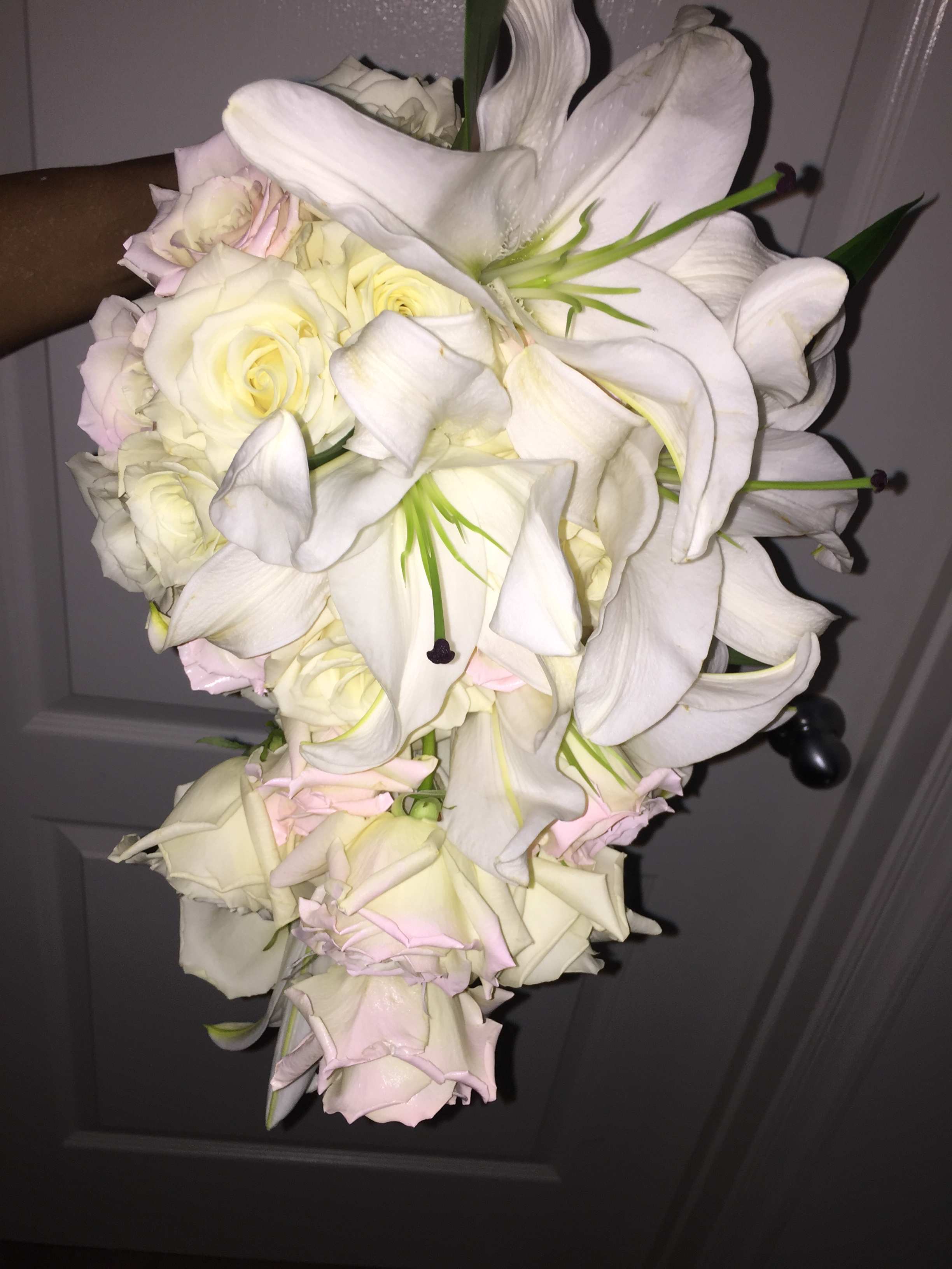 White lilies and pale roses in a cascading bouquet