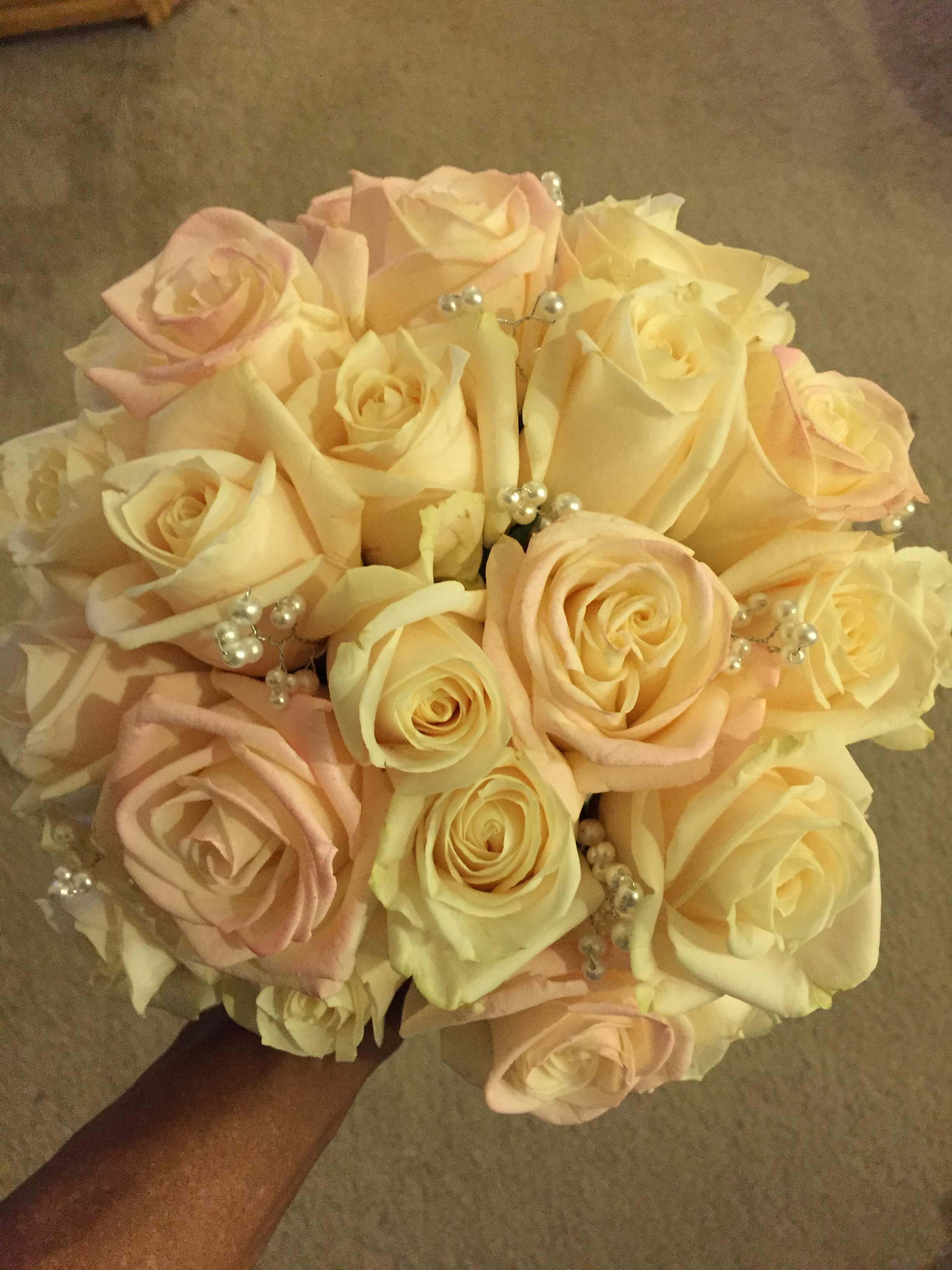 Bouquet of pale pink and cream roses with pearl accents
