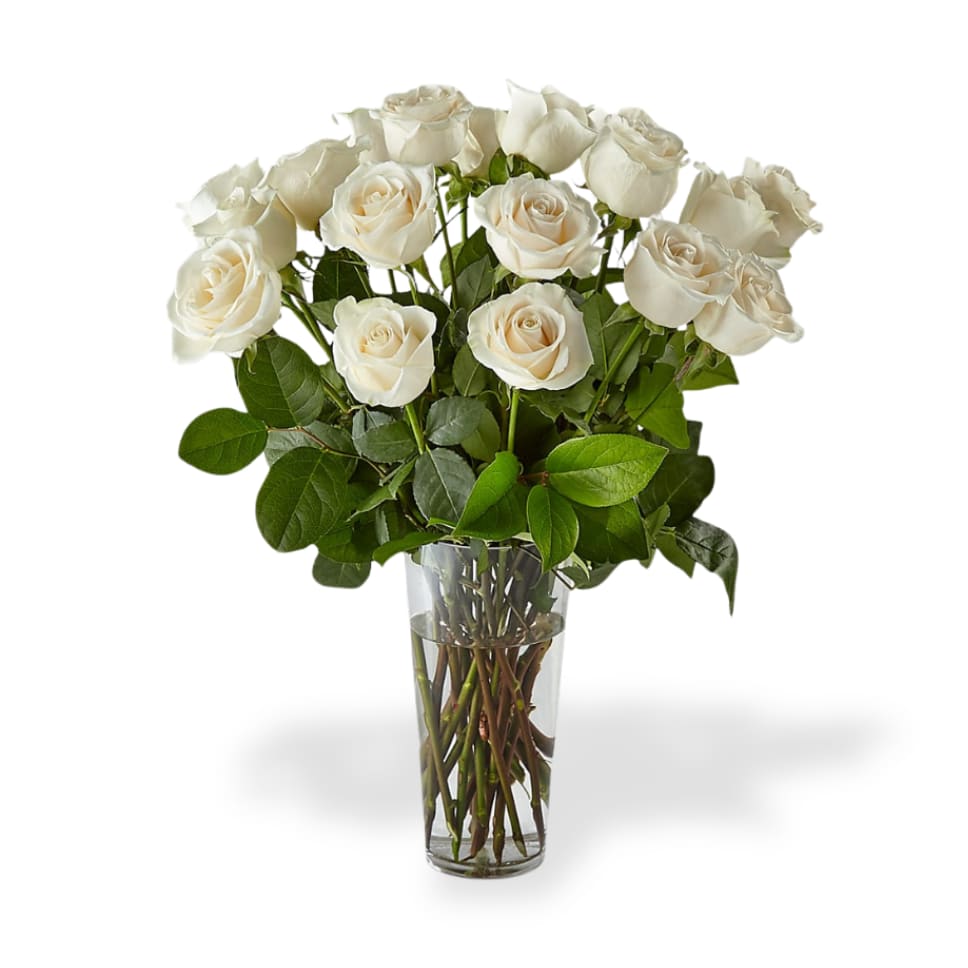White roses arranged in a clear glass vase