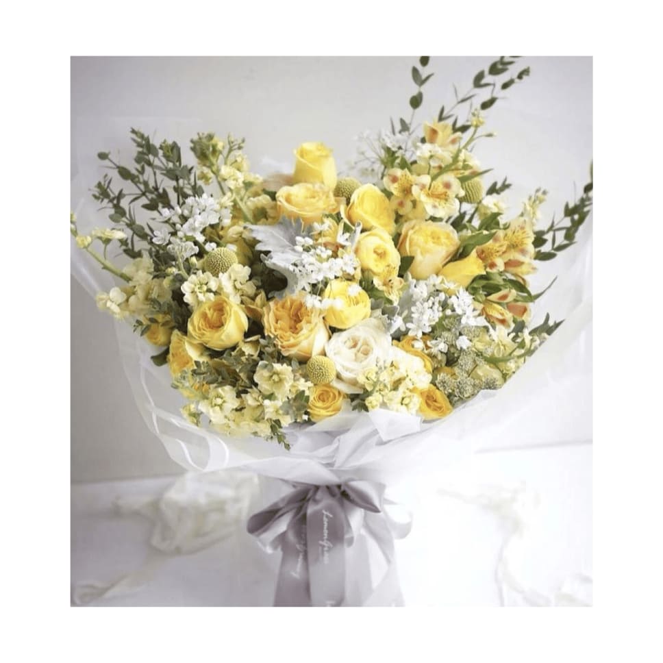 Bouquet of yellow and white roses with white filler flowers