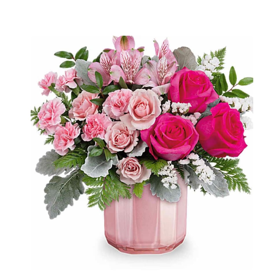 Pink roses and carnations in a pink glass vase