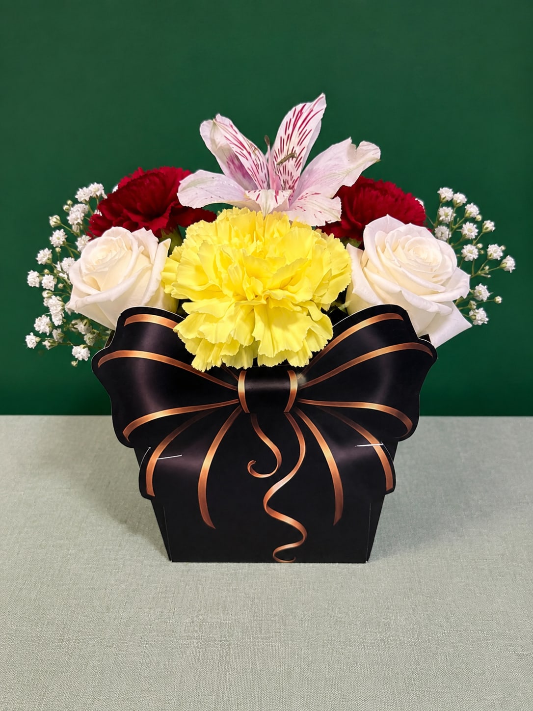 Mixed bouquet in a black gift box with a ribbon bow