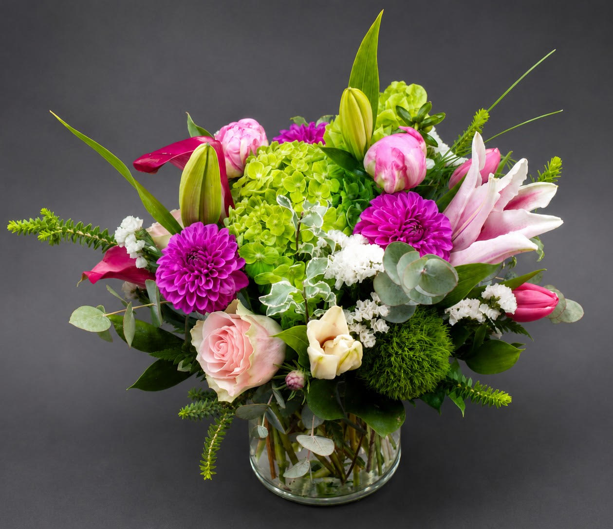 Pink and white mixed flower arrangement in a glass vase