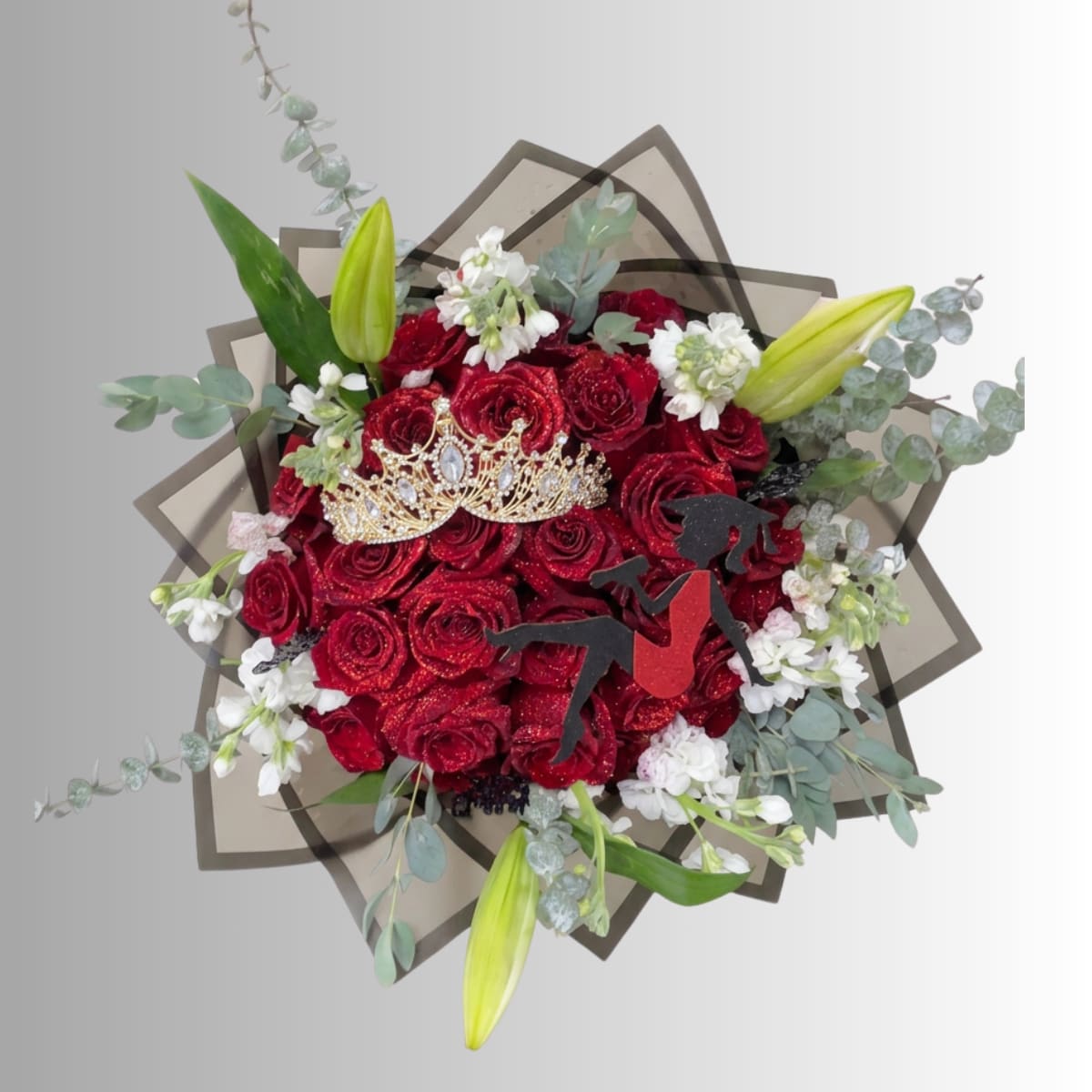 Red rose bouquet with white accents, lilies, and a decorative crown