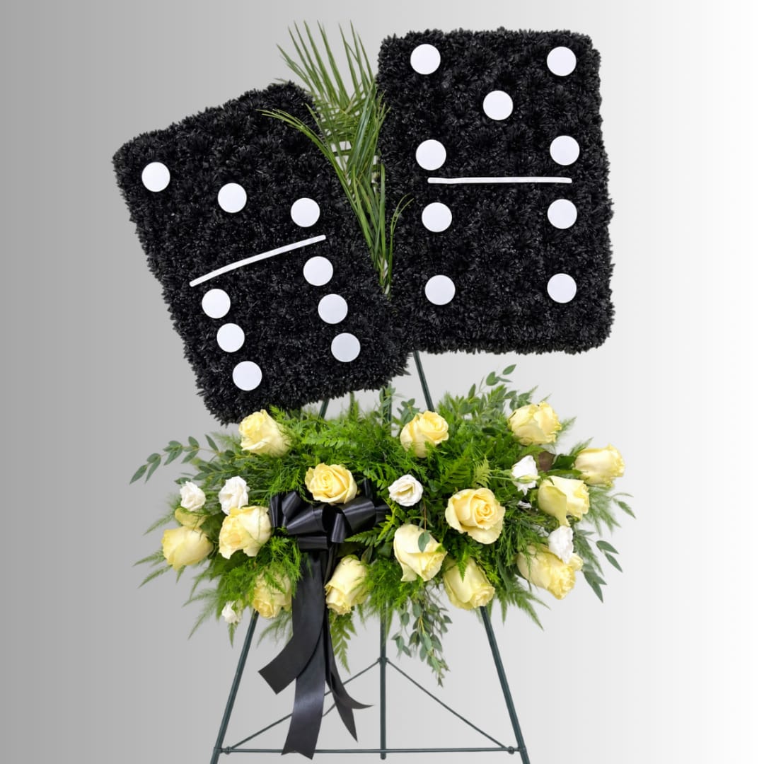 Black floral standing tribute with yellow and white roses on an easel