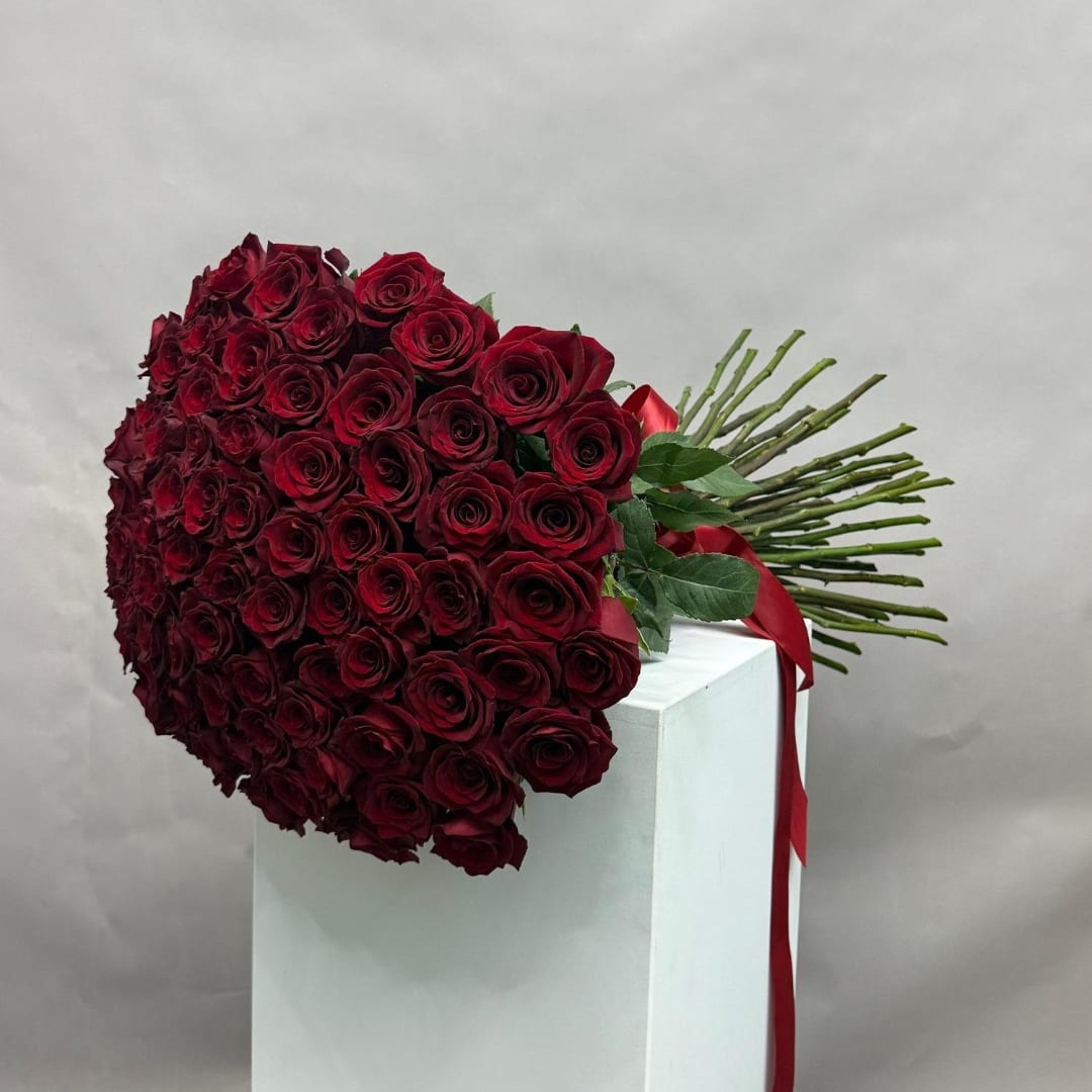 Large bouquet of deep red roses with a red ribbon