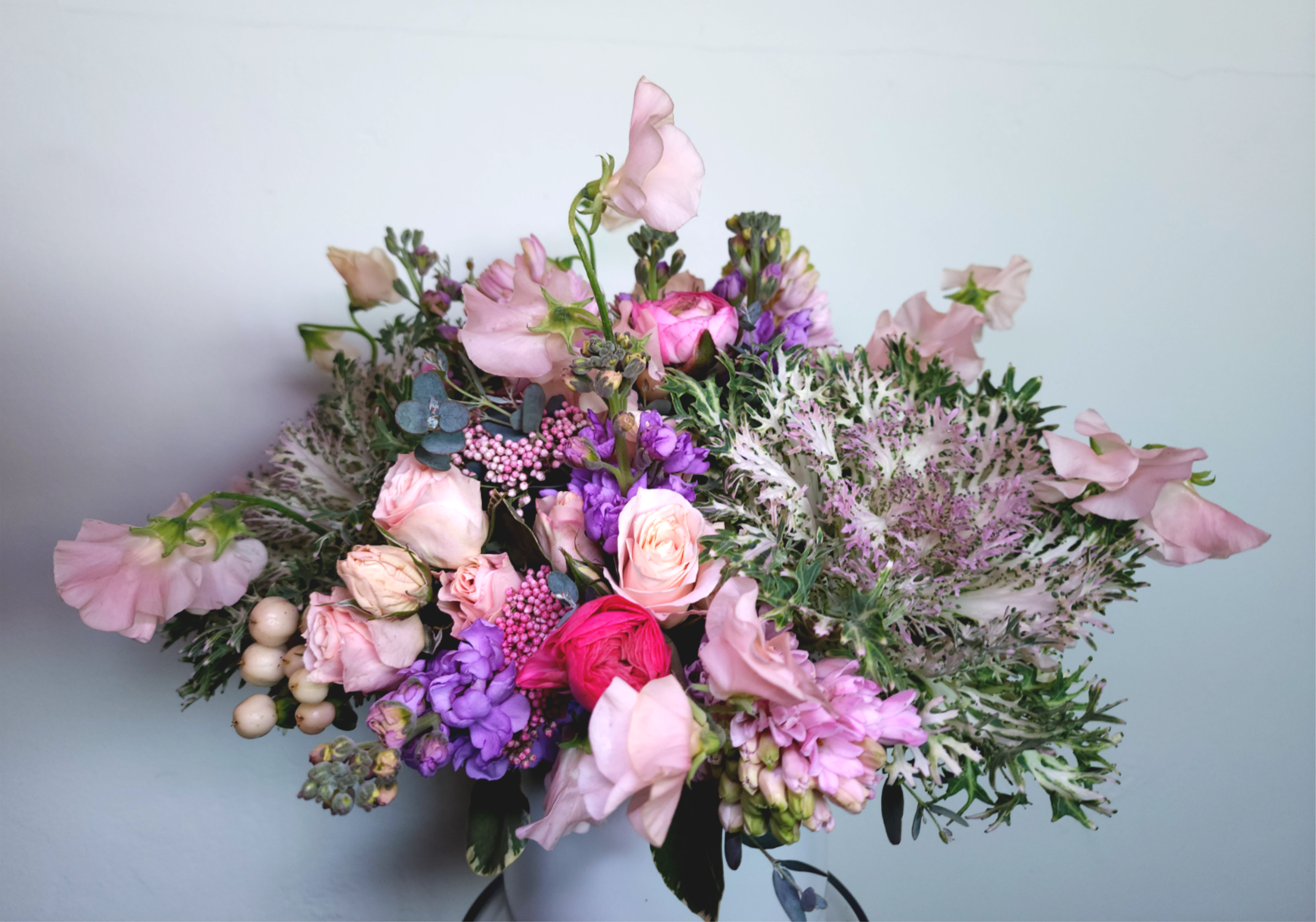 Bouquet of pink and purple flowers with pale greenery