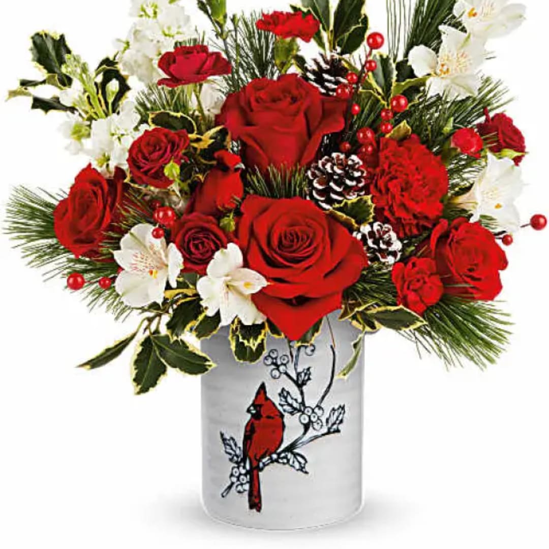 Red roses and white flowers in a white vase with a cardinal design