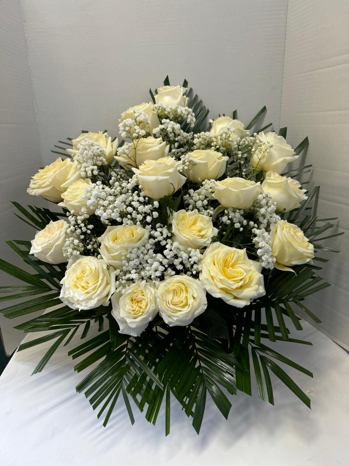 Serenity Arrangement - 24 white roses combined with green foliage