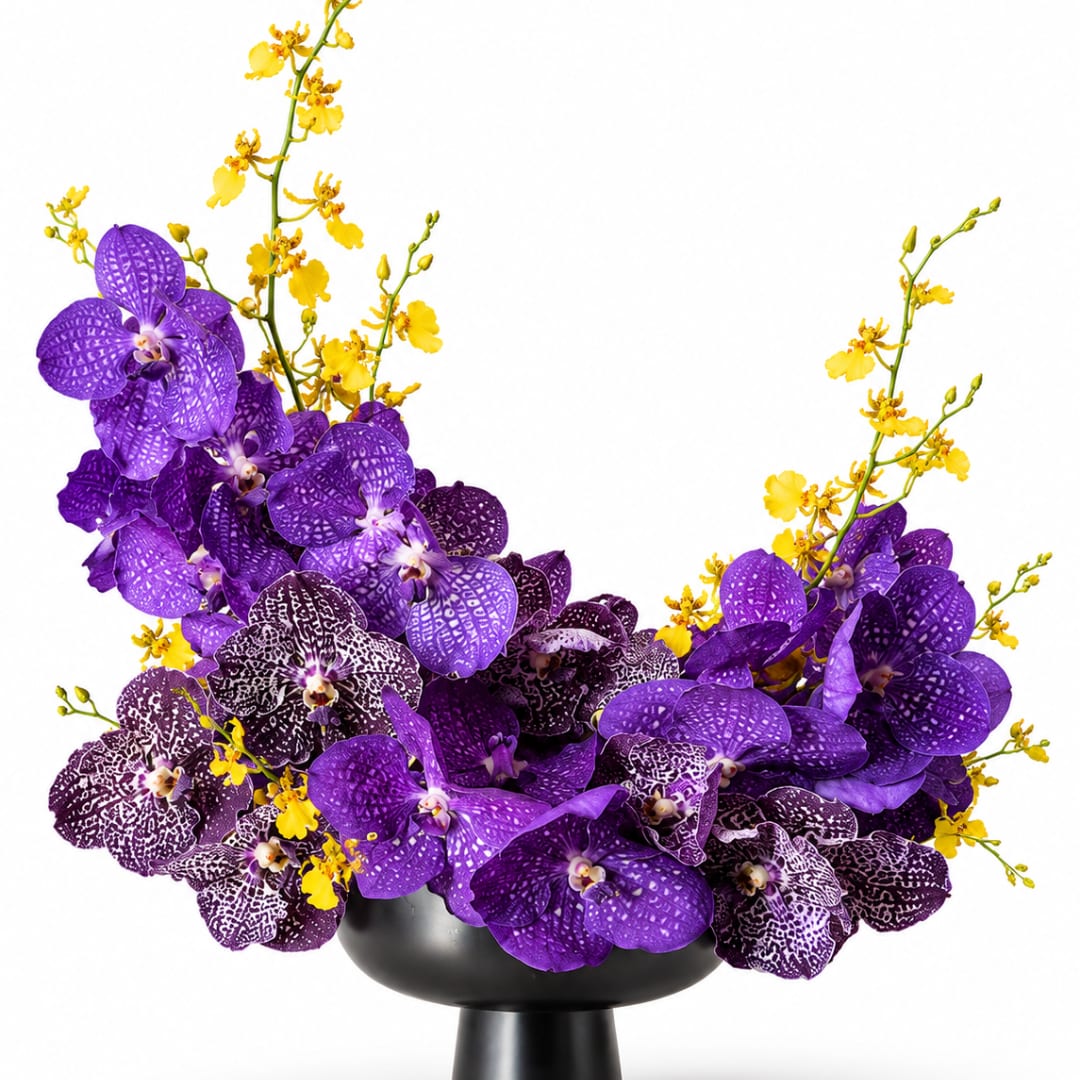Purple orchids and yellow sprays arranged in a black vase