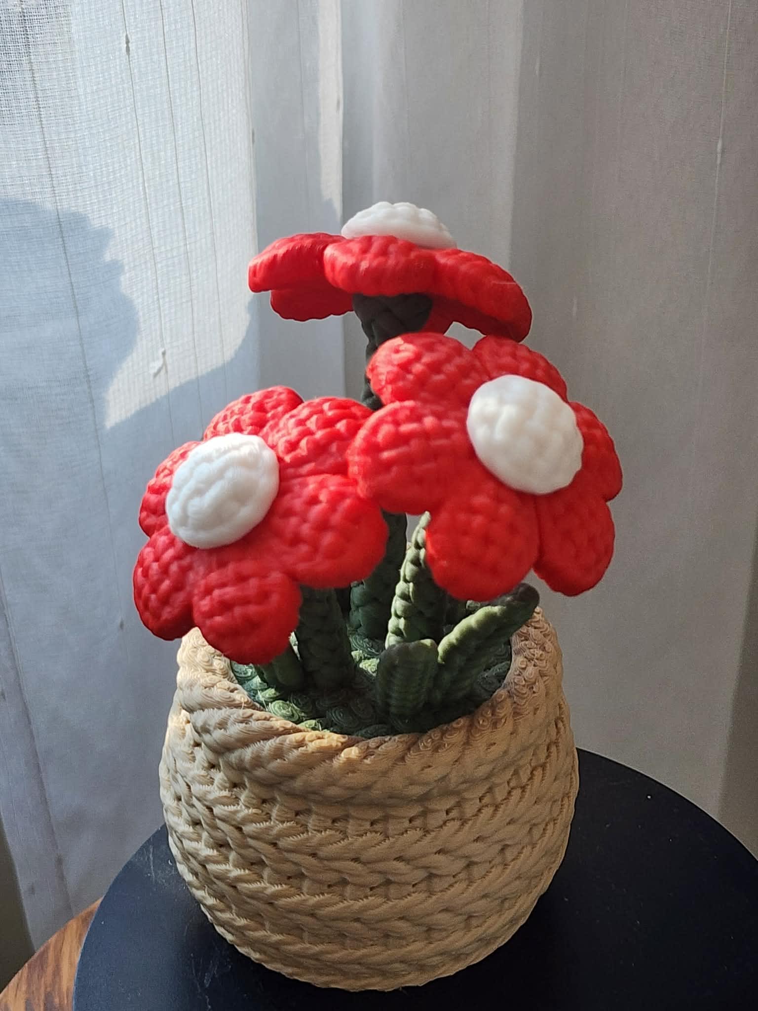 Red and white mushroom-shaped floral sculpture in a woven basket