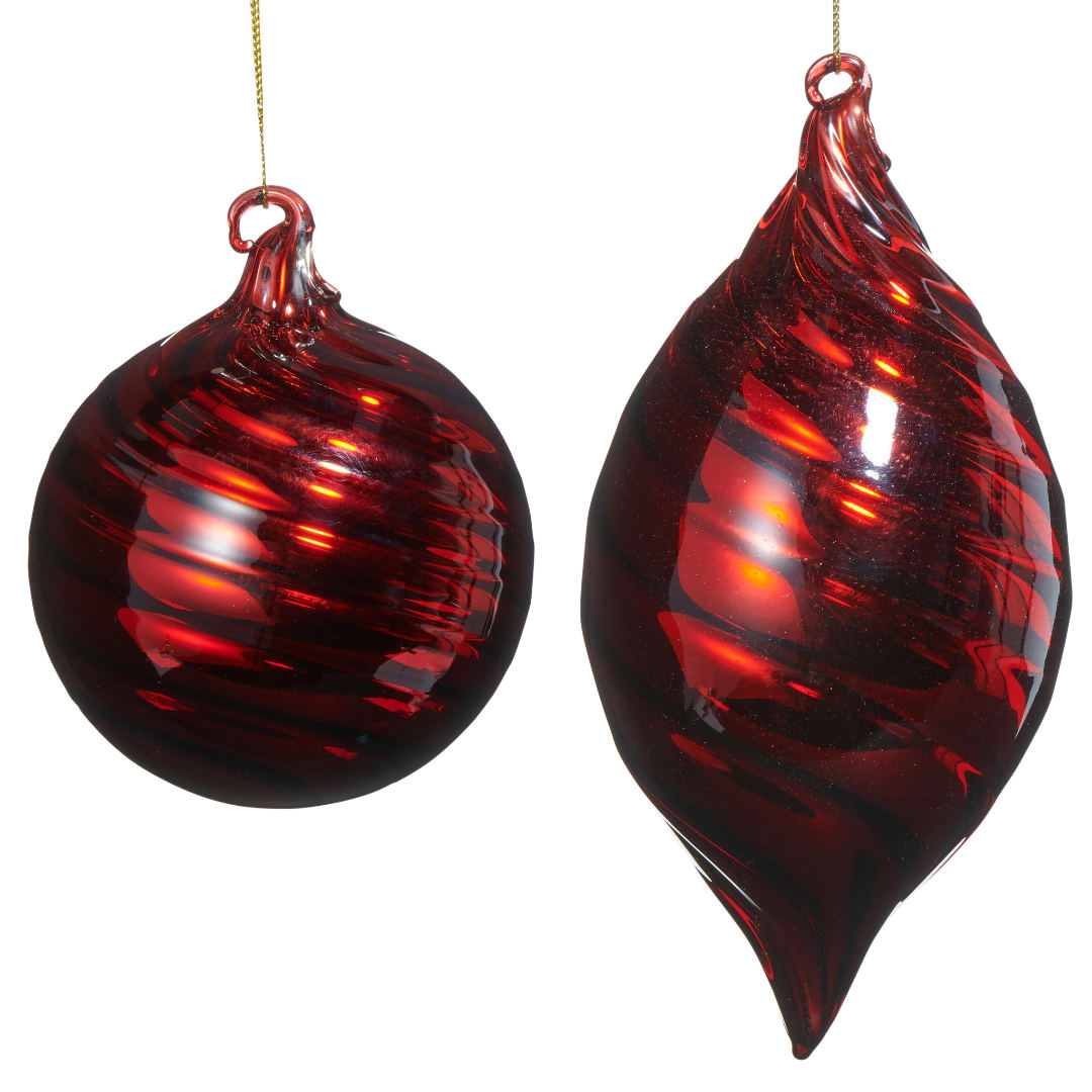 Two red glass Christmas ornaments hanging on strings